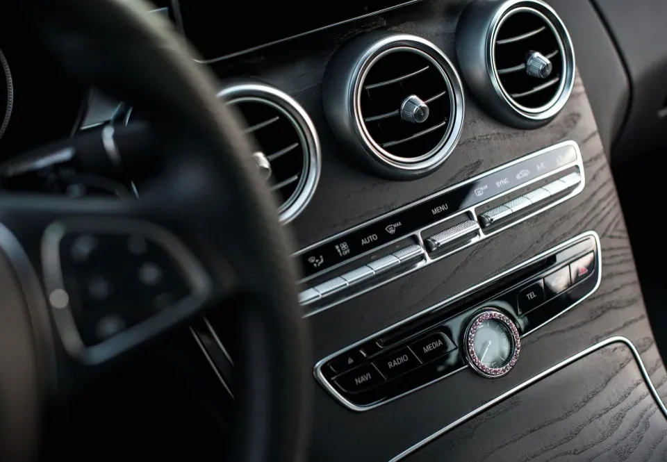 Painel de controle do ar-condicionado em um carro, ilustrando a dúvida se ligar o ar condicionado gasta gasolina.